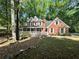Charming two-story brick home with a welcoming front porch and white trim at 894 Oak Rd, Lawrenceville, GA 30044