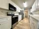 Modern kitchen featuring stainless steel appliances and white cabinets with light countertops at 894 Oak Rd, Lawrenceville, GA 30044