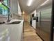 Galley kitchen featuring stainless steel appliances, light countertops, and a view outdoors at 894 Oak Rd, Lawrenceville, GA 30044