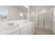 Bathroom featuring double sink vanity, large mirror and glass enclosed shower at 1416 Clear Pond Lane, Dacula, GA 30019