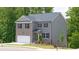 Well-maintained two-story home with brick and gray siding, a two-car garage, and a neatly landscaped front yard at 1416 Clear Pond Lane, Dacula, GA 30019
