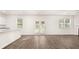 Open-concept living area boasts wood-look floors, double doors to the yard, and a view of the kitchen at 1416 Clear Pond Lane, Dacula, GA 30019