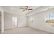 Spacious main bedroom with neutral carpet, a ceiling fan, and ample natural light at 1416 Clear Pond Lane, Dacula, GA 30019