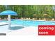 Community pool with plenty of lounge chairs and umbrellas at 1416 Clear Pond Lane, Dacula, GA 30019