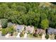 Aerial view of homes with well-maintained lawns and mature trees, showcasing neighborhood charm and curb appeal at 150 Park Creek Dr, Alpharetta, GA 30005