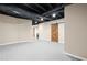An unfinished basement with barn doors and painted floors and ceiling at 150 Park Creek Dr, Alpharetta, GA 30005