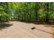Outdoor basketball court surrounded by trees, offering a recreational space for sports and activities at 150 Park Creek Dr, Alpharetta, GA 30005