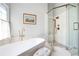 Modern bathroom with a freestanding tub, glass-enclosed shower, and elegant finishes at 150 Park Creek Dr, Alpharetta, GA 30005