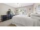 This bedroom features neutral walls, plush carpet, and a bright window view at 150 Park Creek Dr, Alpharetta, GA 30005