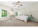 Bright bedroom with two windows showing green foliage, light walls and carpet at 150 Park Creek Dr, Alpharetta, GA 30005