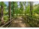 Picturesque wooden bridge surrounded by lush greenery, offering a peaceful escape and scenic views at 150 Park Creek Dr, Alpharetta, GA 30005