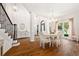 Elegant dining room with hardwood floors, wainscoting, and ample seating for entertaining at 150 Park Creek Dr, Alpharetta, GA 30005