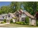 Well-maintained home featuring a landscaped yard and a charming exterior with stone and stucco at 150 Park Creek Dr, Alpharetta, GA 30005
