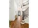 Stunning foyer with soaring ceilings, hardwood floors and elegant staircase with iron railings at 150 Park Creek Dr, Alpharetta, GA 30005