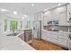Bright kitchen featuring stainless appliances, marble countertops, and wooden floors at 150 Park Creek Dr, Alpharetta, GA 30005