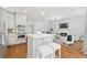 Open-concept kitchen featuring stainless steel appliances, large island, and seamless access to the living room at 150 Park Creek Dr, Alpharetta, GA 30005