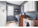 Functional laundry room featuring modern appliances, ample counter space, and storage cabinets at 150 Park Creek Dr, Alpharetta, GA 30005
