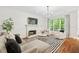 Bright living room featuring a fireplace, hardwood floors and large windows offering ample natural light at 150 Park Creek Dr, Alpharetta, GA 30005