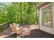 A spacious deck with two chairs and a beautiful wooded backyard at 150 Park Creek Dr, Alpharetta, GA 30005