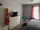 Bedroom with neutral colors, dresser, and window with red curtains at 3231 Abbeywood Dr, Decatur, GA 30034