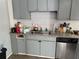 Efficient kitchen with stainless steel dishwasher, granite countertops, and gray cabinets at 3231 Abbeywood Dr, Decatur, GA 30034