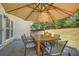 Outdoor dining area under a large patio umbrella offering a serene spot to enjoy outdoor meals and gatherings at 6330 Beaver Crossing Dr, Cumming, GA 30040