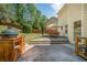Inviting back patio with outdoor kitchen, dining area and beautifully landscaped backyard, perfect for entertaining at 6330 Beaver Crossing Dr, Cumming, GA 30040