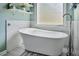 Bright bathroom featuring a standalone tub with modern fixtures and stylish decor at 6330 Beaver Crossing Dr, Cumming, GA 30040