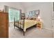 Cozy bedroom with natural light and a decorative wrought iron bed frame at 6330 Beaver Crossing Dr, Cumming, GA 30040