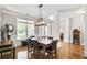 Elegant dining room with hardwood floors, wainscoting, and a modern chandelier at 6330 Beaver Crossing Dr, Cumming, GA 30040