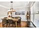 Open dining area with hardwood floors, wainscoting, and stylish lighting at 6330 Beaver Crossing Dr, Cumming, GA 30040