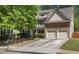 Inviting two-story home featuring a two-car garage, landscaped yard and traditional architectural details at 6330 Beaver Crossing Dr, Cumming, GA 30040