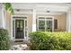 Charming covered front porch with classic columns and decorative shrubbery offers curb appeal at 6330 Beaver Crossing Dr, Cumming, GA 30040