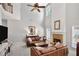 Comfortable living room with a fireplace, high ceilings, and a cozy seating arrangement at 6330 Beaver Crossing Dr, Cumming, GA 30040