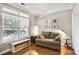 Sunlit living room with hardwood floors, a large window, neutral paint, and comfortable seating area at 6330 Beaver Crossing Dr, Cumming, GA 30040