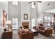 Bright living room with a fireplace, soaring ceilings, and comfortable leather sofas at 6330 Beaver Crossing Dr, Cumming, GA 30040