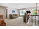Cozy loft area with comfortable seating, a large window, and a stylish chandelier at 6330 Beaver Crossing Dr, Cumming, GA 30040