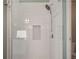 A newly remodeled shower featuring white subway tiles and a built-in shampoo nook at 6330 Beaver Crossing Dr, Cumming, GA 30040