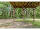 View beneath the wooden deck reveals the home's architectural details and the tranquil surrounding nature at 110 Slate Ridge Ln, Loganville, GA 30052