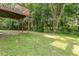 Expansive backyard featuring lush greenery and a wooden deck overlooking the serene landscape at 110 Slate Ridge Ln, Loganville, GA 30052