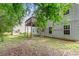 View of backyard with deck and home exterior featuring mature trees and partial shade at 110 Slate Ridge Ln, Loganville, GA 30052
