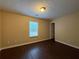 Neutral-toned bedroom with laminate floors and a window with natural light at 110 Slate Ridge Ln, Loganville, GA 30052