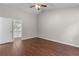 Bedroom with wood-look floors and an open door that leads to the bathroom at 110 Slate Ridge Ln, Loganville, GA 30052
