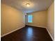 Bright bedroom features dark floors, tan walls, and a window offering natural light at 110 Slate Ridge Ln, Loganville, GA 30052