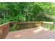 The wooden deck overlooks backyard with lush greenery at 110 Slate Ridge Ln, Loganville, GA 30052