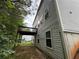 A view of the home's rear corner with a brown deck and light siding at 110 Slate Ridge Ln, Loganville, GA 30052