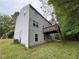 A lawn view of the house with light siding and a second story brown deck at 110 Slate Ridge Ln, Loganville, GA 30052