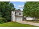 Beautiful two-story home boasts a two-car garage, stone accents, and a lovely landscaped front yard at 110 Slate Ridge Ln, Loganville, GA 30052