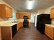 Kitchen featuring wood cabinets and black appliances and access to back yard at 110 Slate Ridge Ln, Loganville, GA 30052
