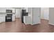 Well-lit kitchen with stainless steel appliances, white cabinets, and door to the side of the house at 110 Slate Ridge Ln, Loganville, GA 30052